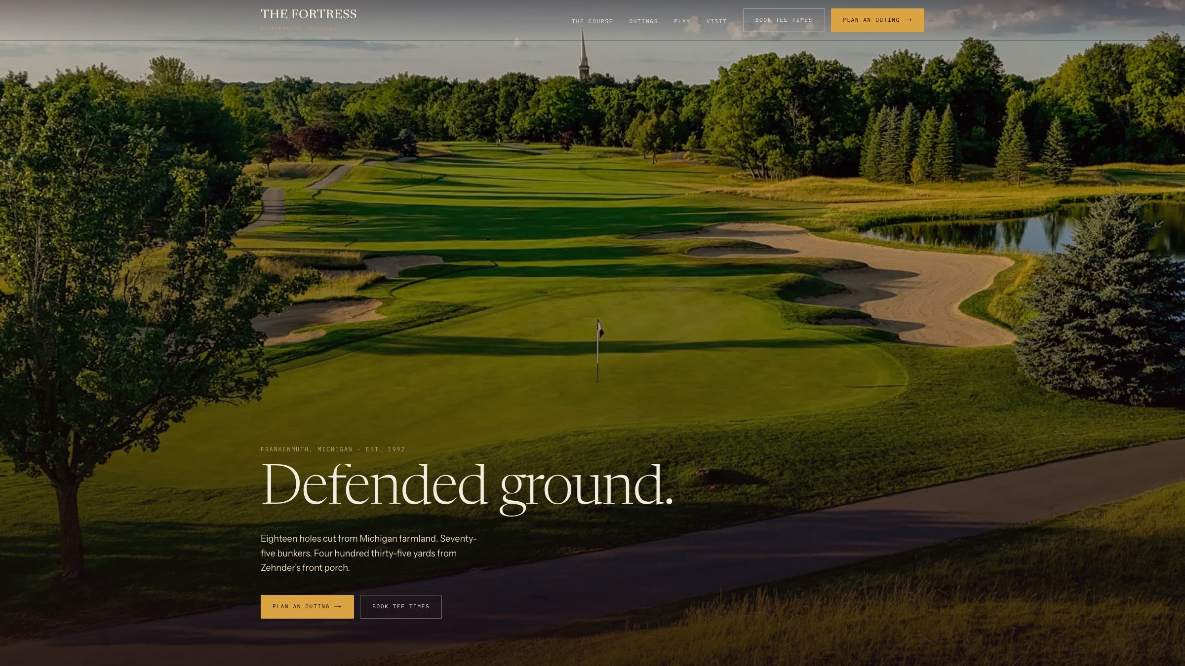 The Fortress Golf Club website homepage: Defended ground set over a golden-hour aerial toward the Frankenmuth steeple